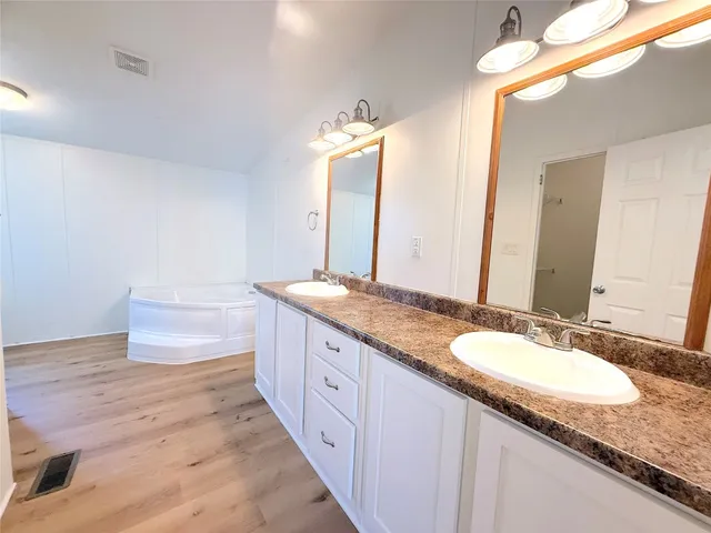 a bathroom with a tub and a shower