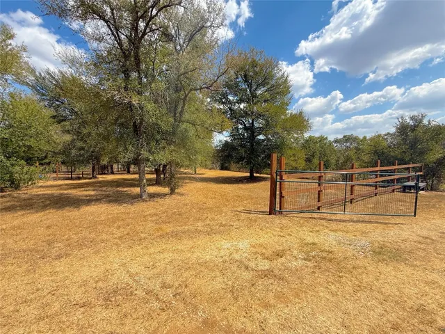 a view of yard with swimming pool and trees