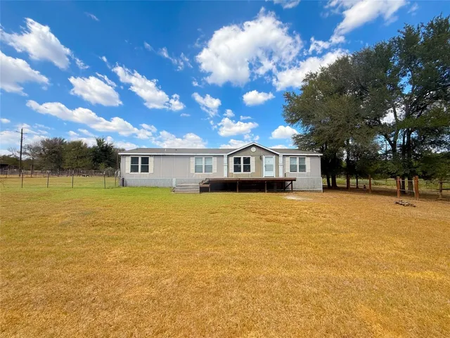 a front view of house with yard swimming pool and outdoor seating