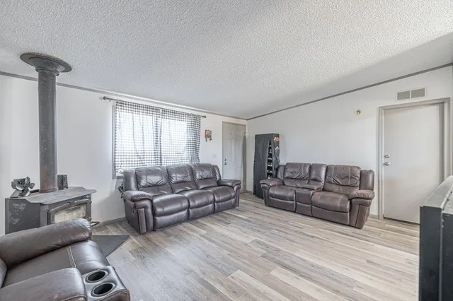 a living room with couch and a wooden floor