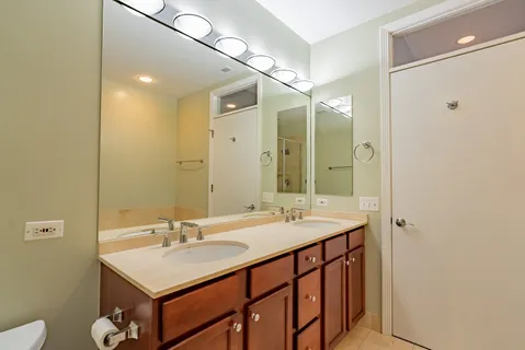 a bathroom with a sink double vanity and a mirror