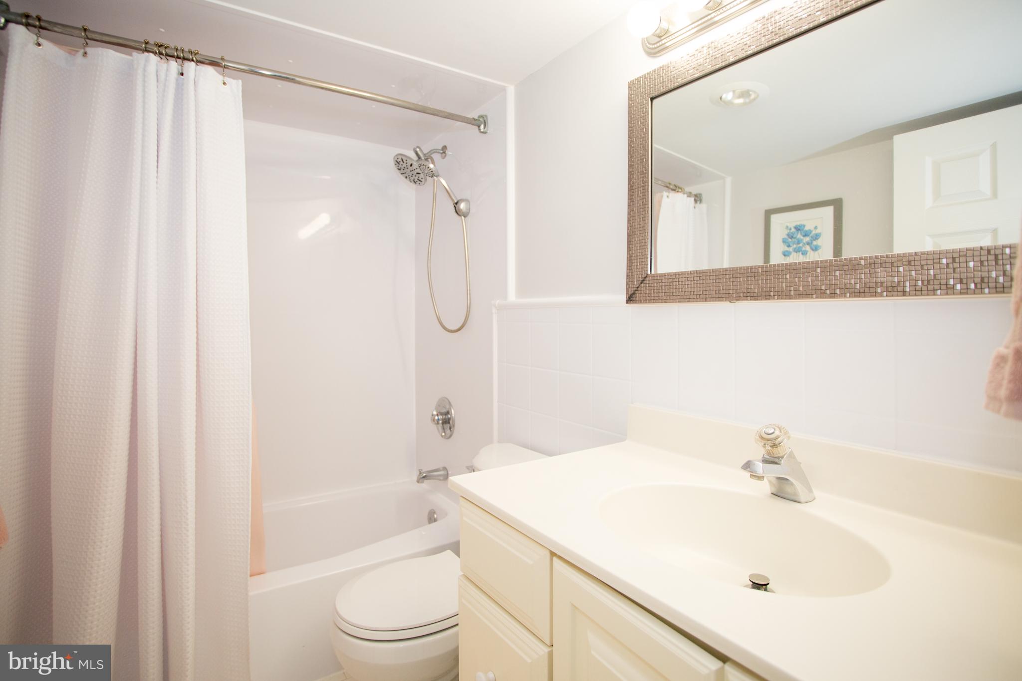 2304 Riddle Avenue, Unit 307 Wilmington, DE 19806 - Photo 14 of 23 a bathroom with a sink a toilet and shower