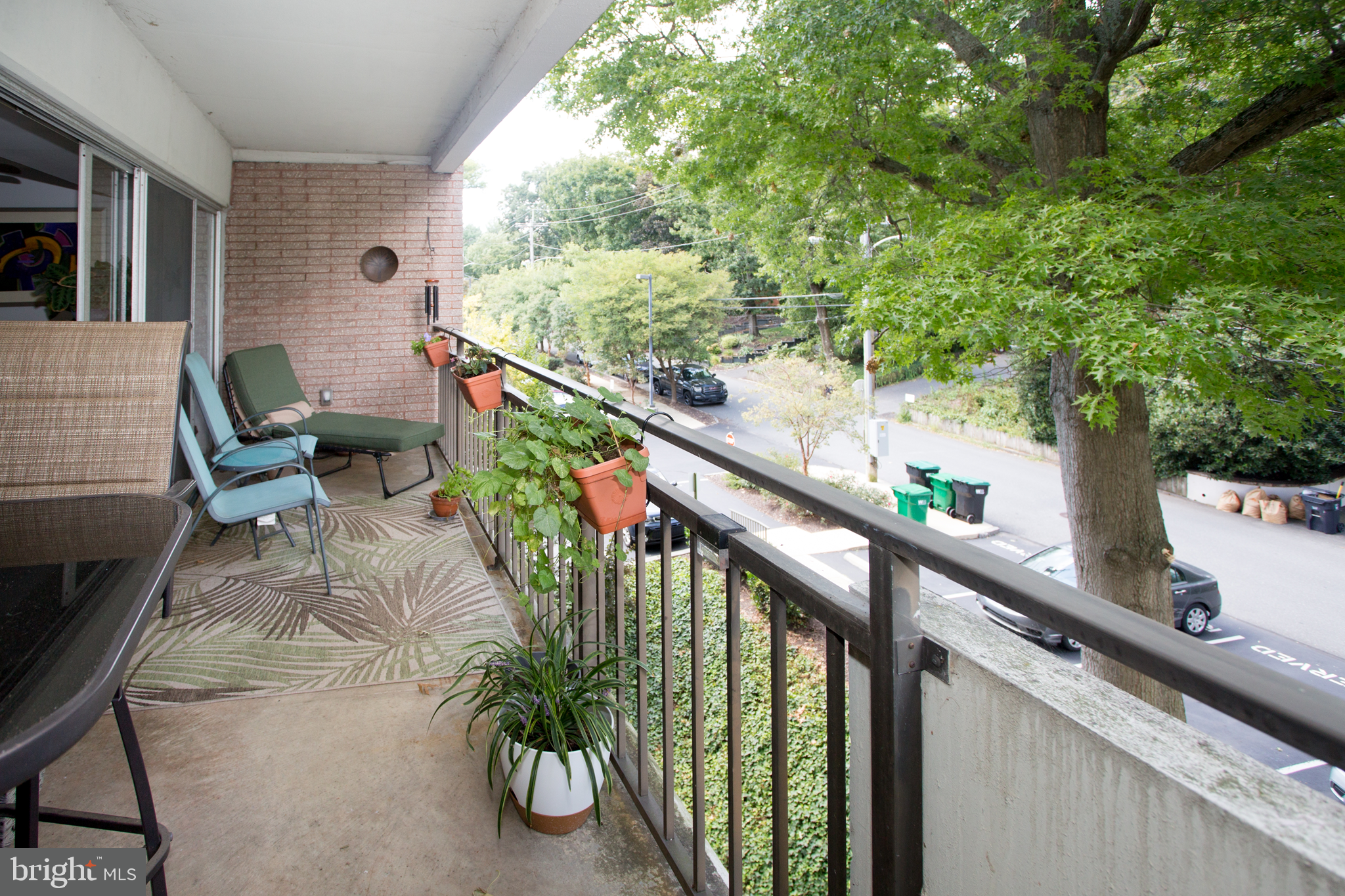 2304 Riddle Avenue, Unit 307 Wilmington, DE 19806 - Photo 19 of 23 a balcony with wooden floor and outdoor seating