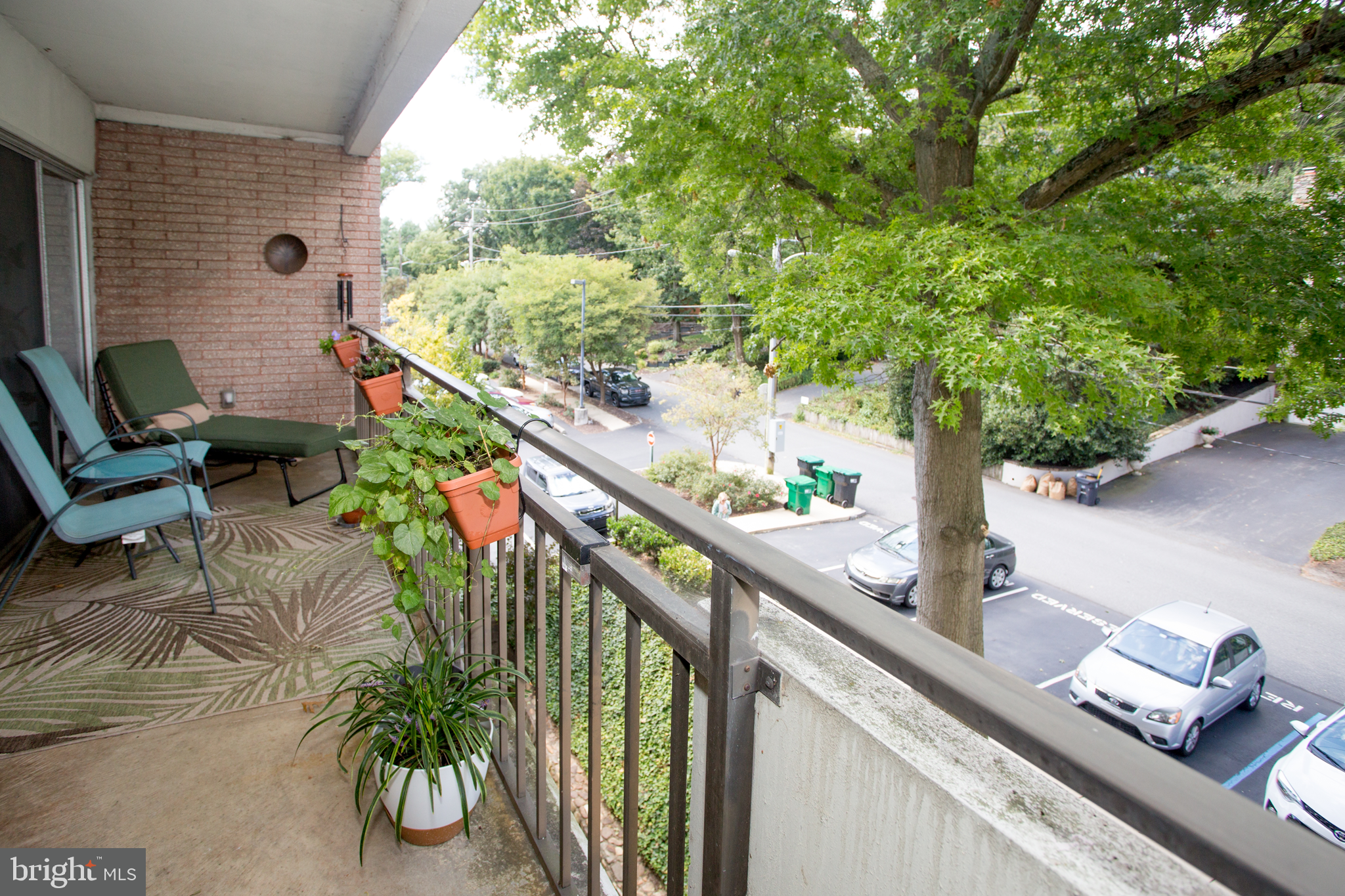 2304 Riddle Avenue, Unit 307 Wilmington, DE 19806 - Photo 20 of 23 a balcony with wooden floor and outdoor seating