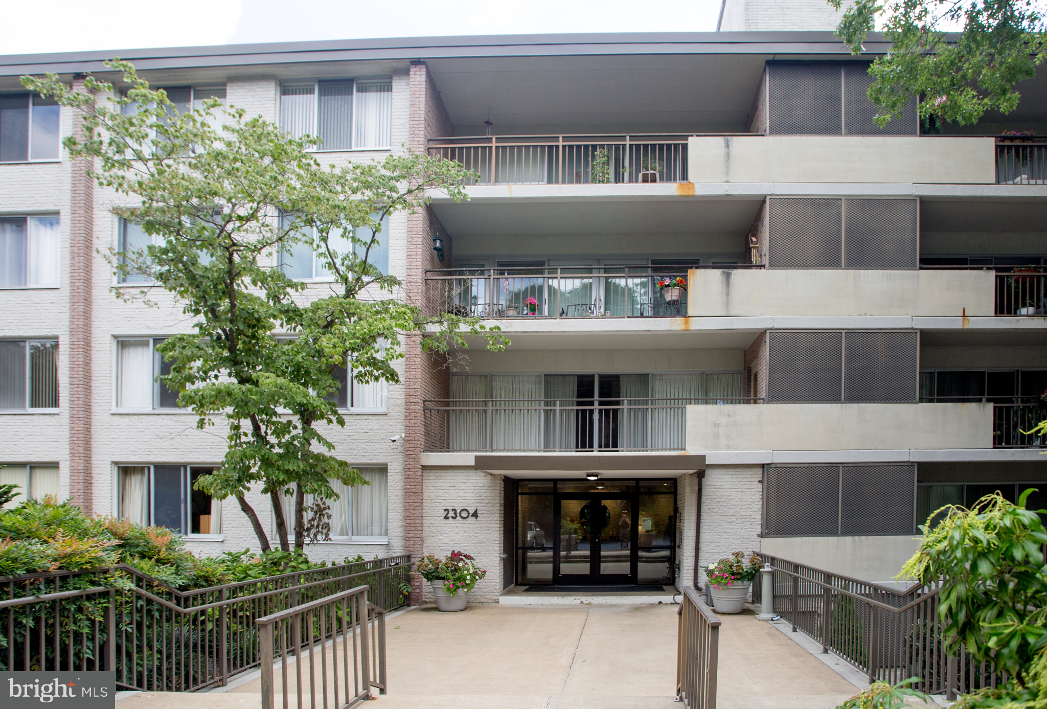 2304 Riddle Avenue, Unit 307 Wilmington, DE 19806 - Photo 2 of 23 a front view of a house with a yard