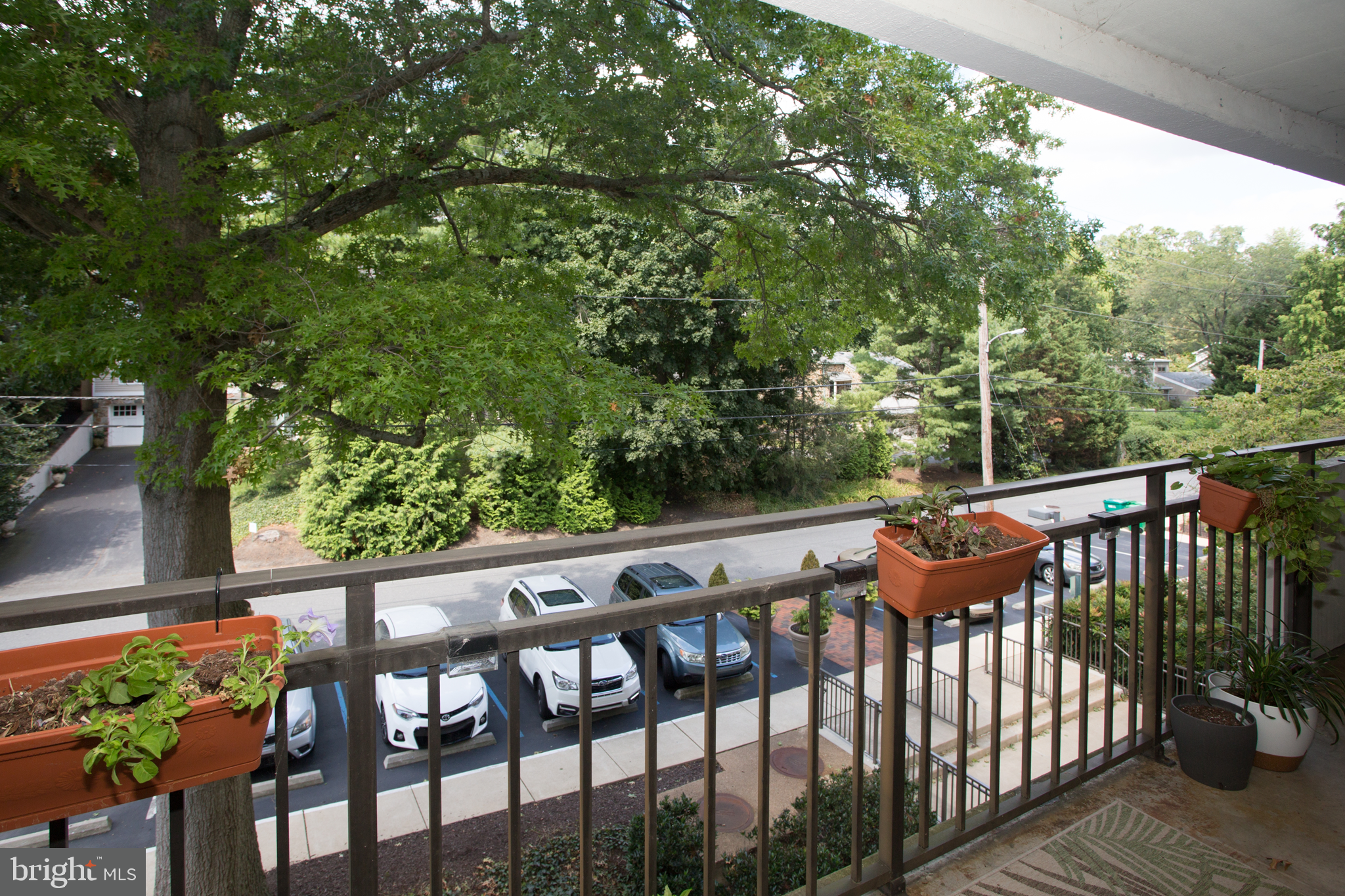 2304 Riddle Avenue, Unit 307 Wilmington, DE 19806 - Photo 21 of 23 a view of a wooden chairs and table in the balcony