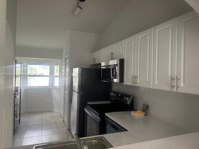 2920 Southeast 12th Road, Unit 20530 Homestead, FL 33035 - Photo 5 of 10 a kitchen with stainless steel appliances a refrigerator and a stove top oven
