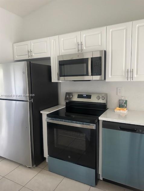 2920 Southeast 12th Road, Unit 20530 Homestead, FL 33035 - Photo 6 of 10 a kitchen with stainless steel appliances granite countertop a stove a refrigerator and a microwave