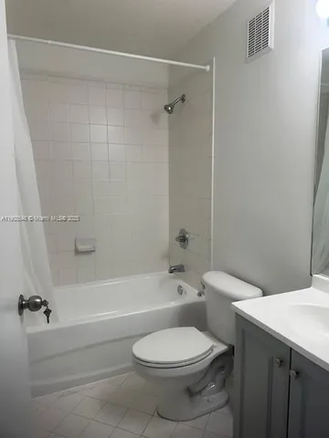 a bathroom with a toilet and a bath tub