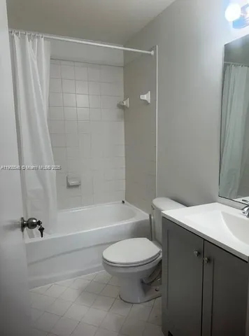 a bathroom with a toilet a sink and shower
