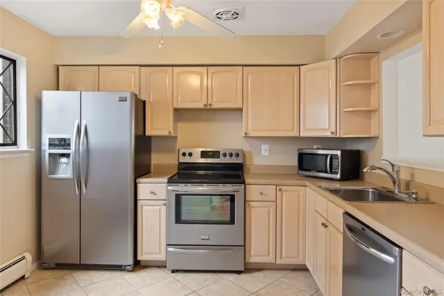 a kitchen with a refrigerator sink and cabinets