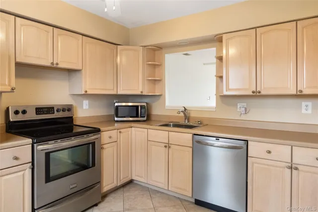 a kitchen with cabinets appliances and a sink