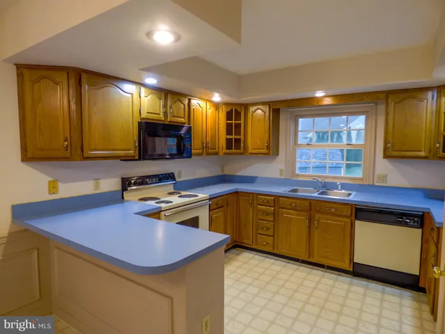 a kitchen with wooden cabinets and a sink
