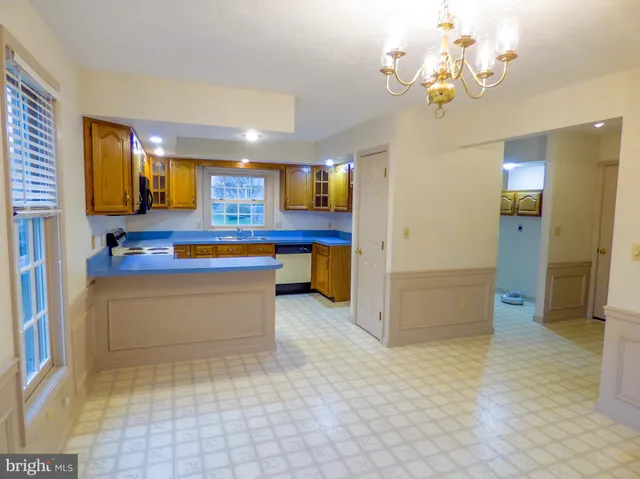 a kitchen with stainless steel appliances granite countertop a sink and a refrigerator