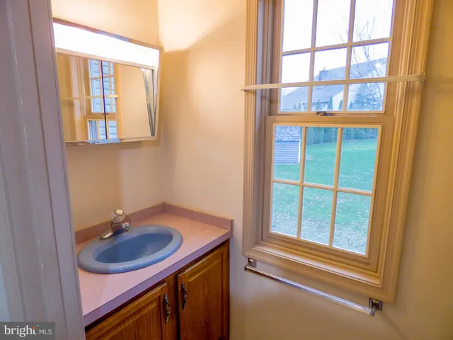 a bathroom with a sink and a window