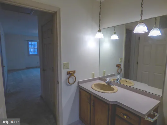 a bathroom with a sink a mirror and a light fixture