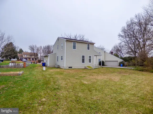 a view of an empty room with fireplace and stairs