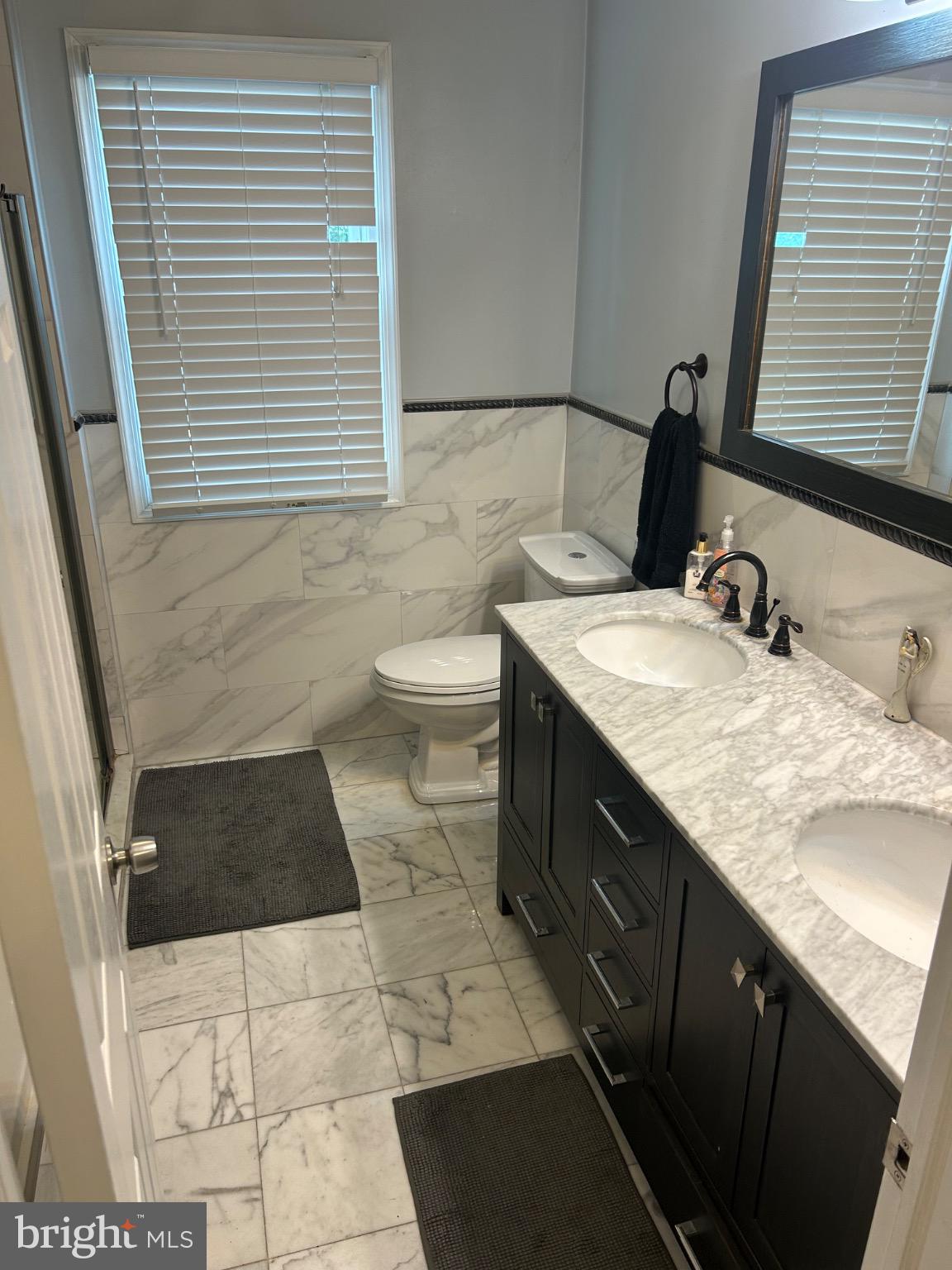 159 Planebrook Road Malvern, PA 19355 - Photo 28 of 30 a bathroom with a granite countertop sink a toilet and a vanity