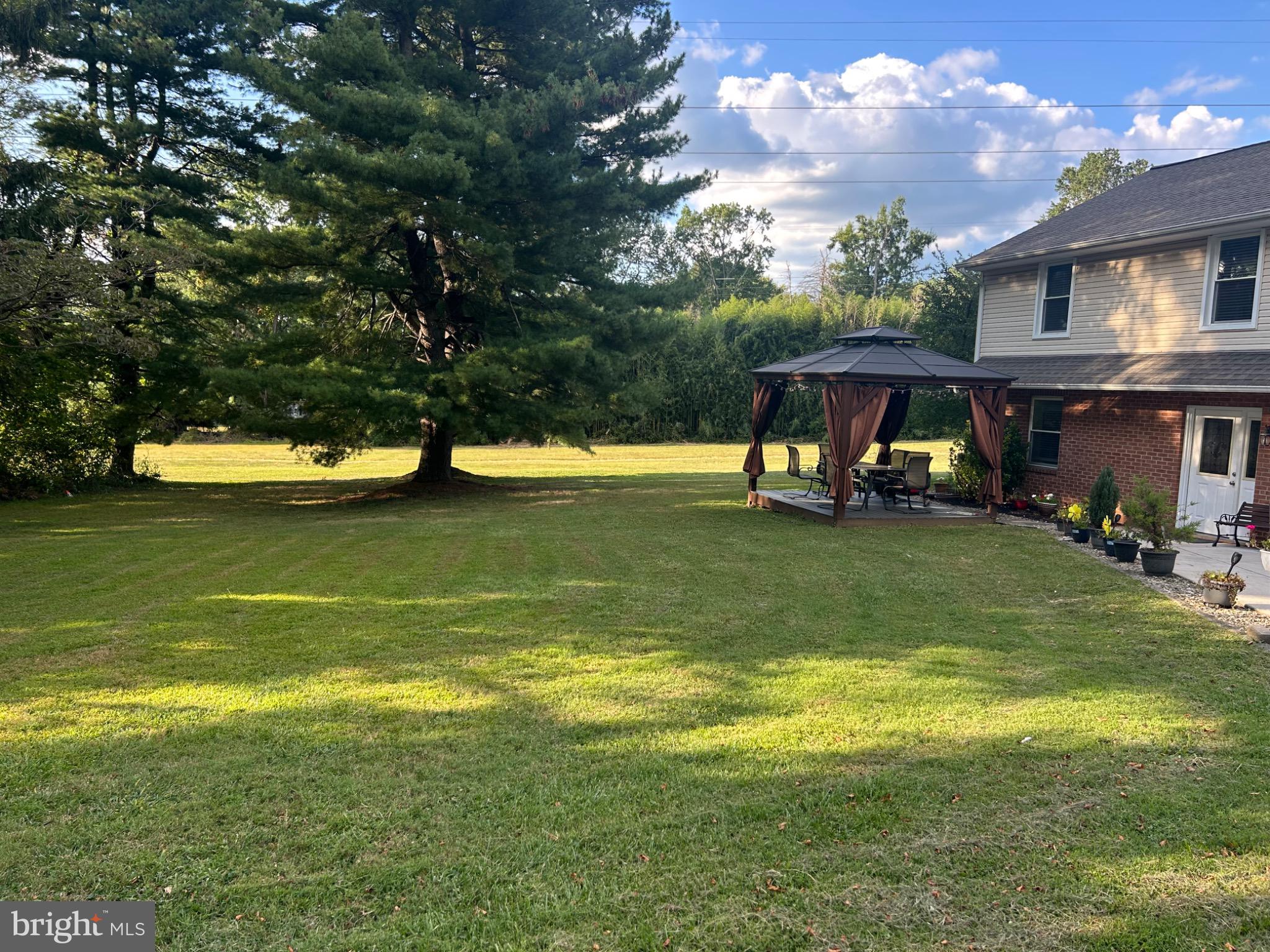 159 Planebrook Road Malvern, PA 19355 - Photo 4 of 30 a view of a swimming pool with lawn chairs and a big yard