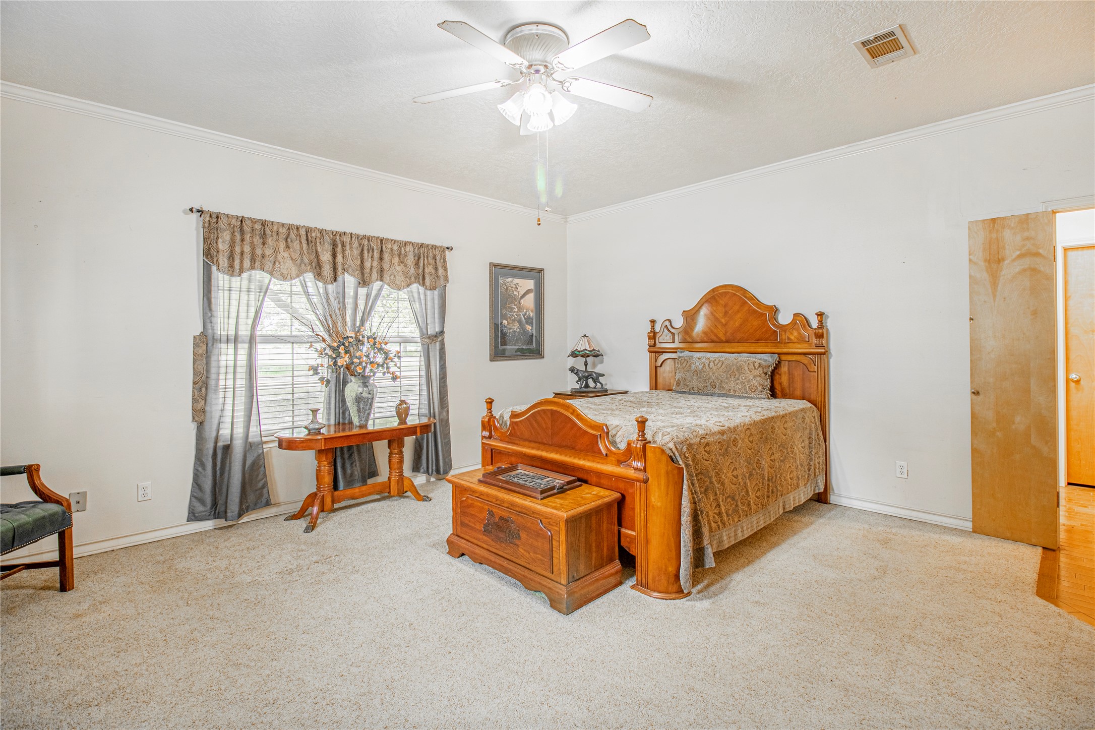 9310 South Business 6 Navasota, TX 77868 - Photo 17 of 48 a bedroom with a bed and a chandelier