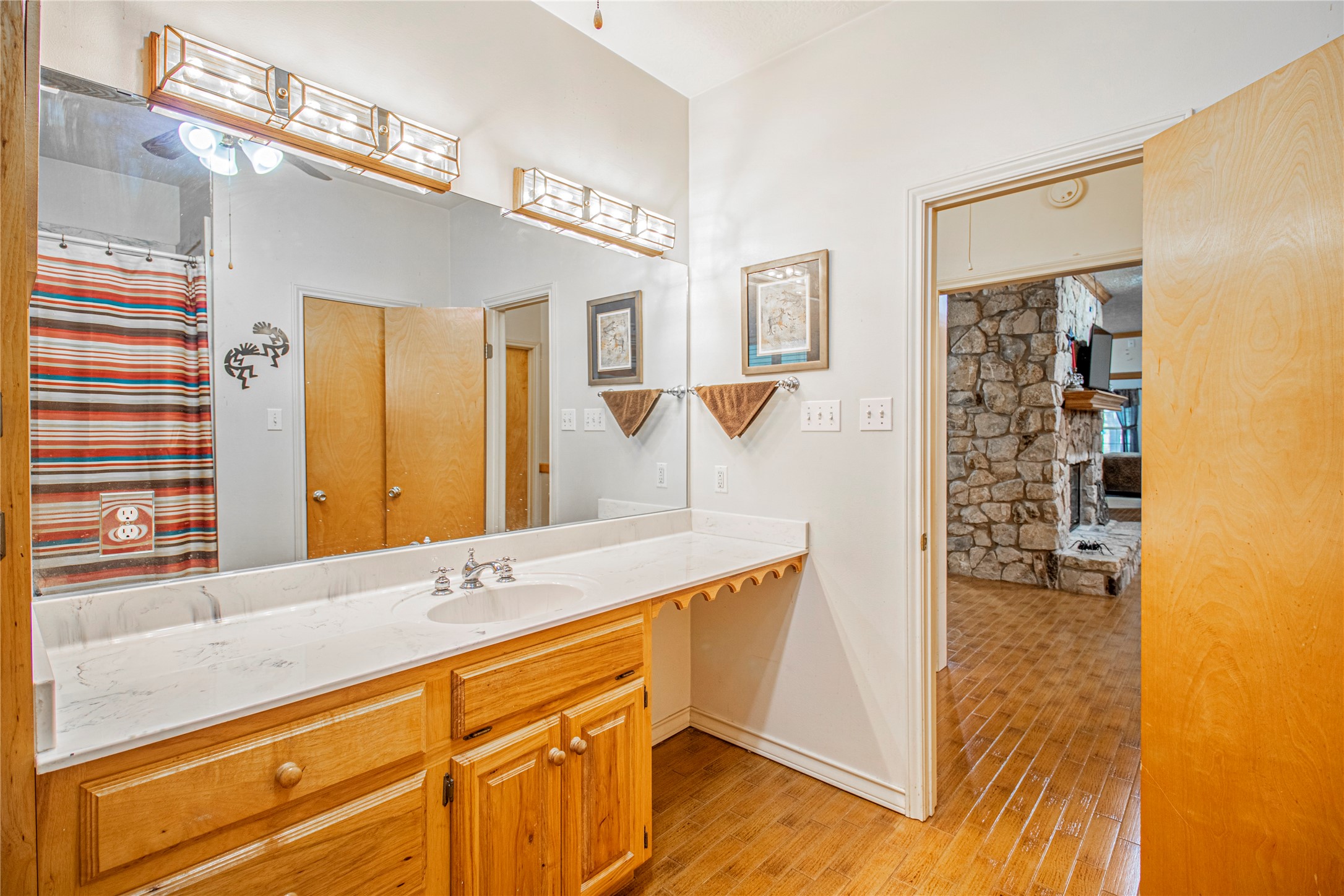 9310 South Business 6 Navasota, TX 77868 - Photo 27 of 48 a bathroom with a granite countertop sink a mirror and a shower