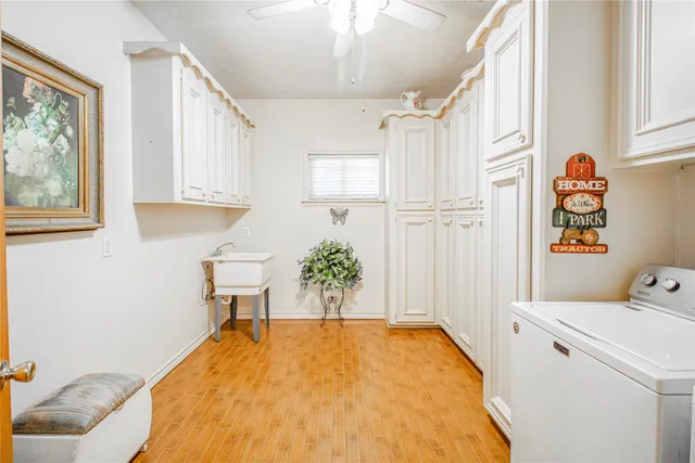 a kitchen with cabinets and wooden floor