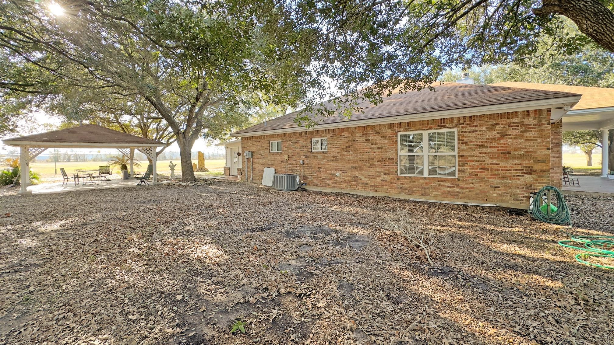 9310 South Business 6 Navasota, TX 77868 - Photo 41 of 48 a front view of a house with a garden