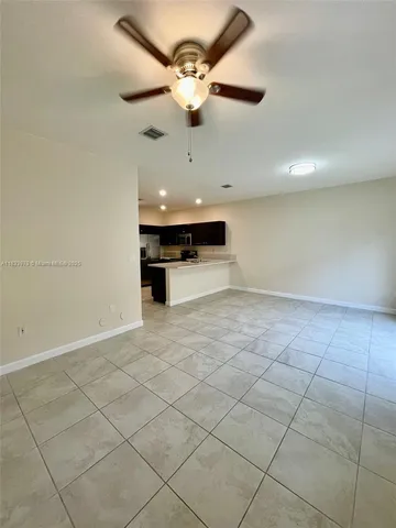 a view of a kitchen with a sink and cabinets