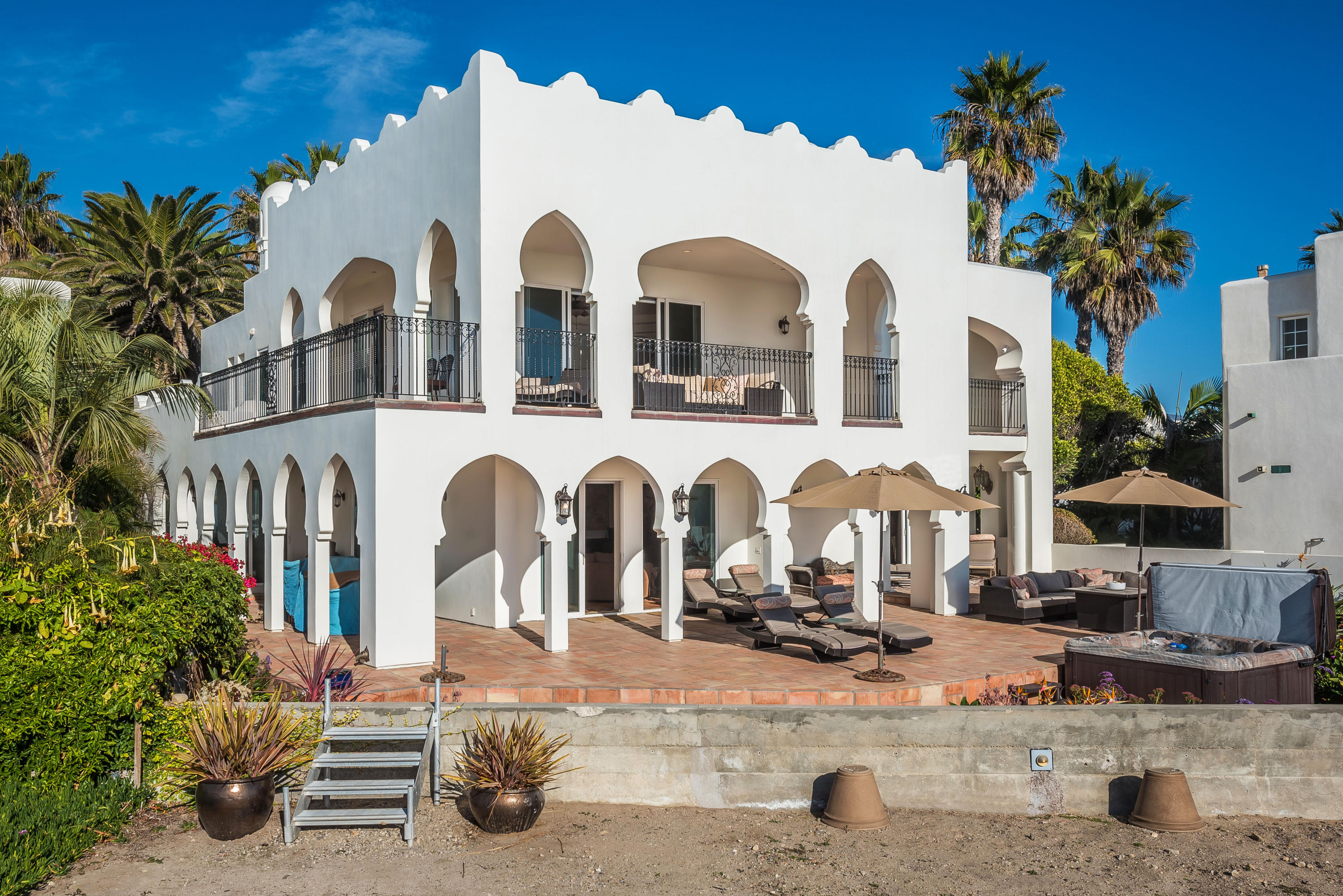 875 Sand Point Road Carpinteria, CA 93013 - Photo 1 of 25 a front view of a house with a garden