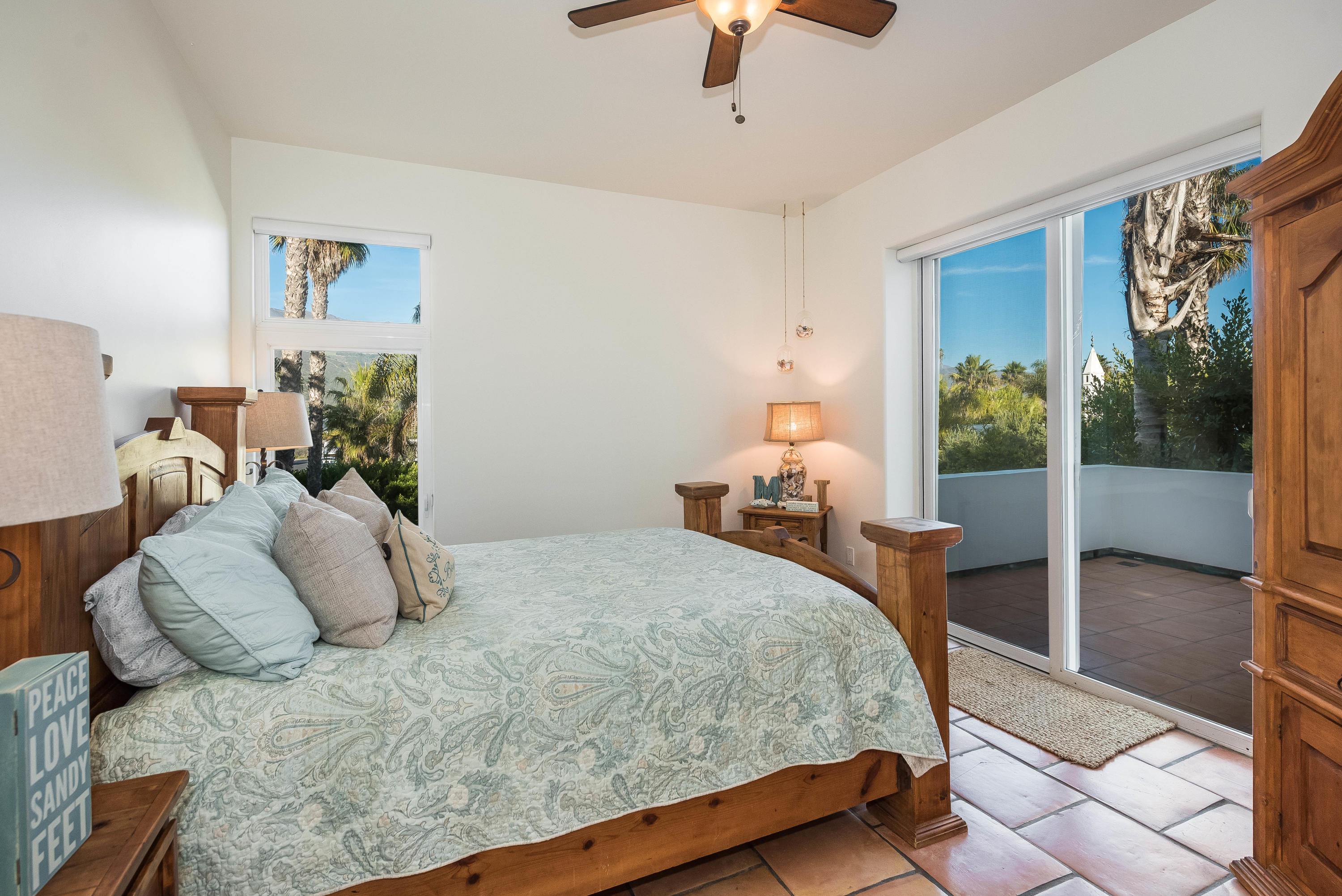 875 Sand Point Road Carpinteria, CA 93013 - Photo 14 of 25 a bedroom with a bed and wooden floor