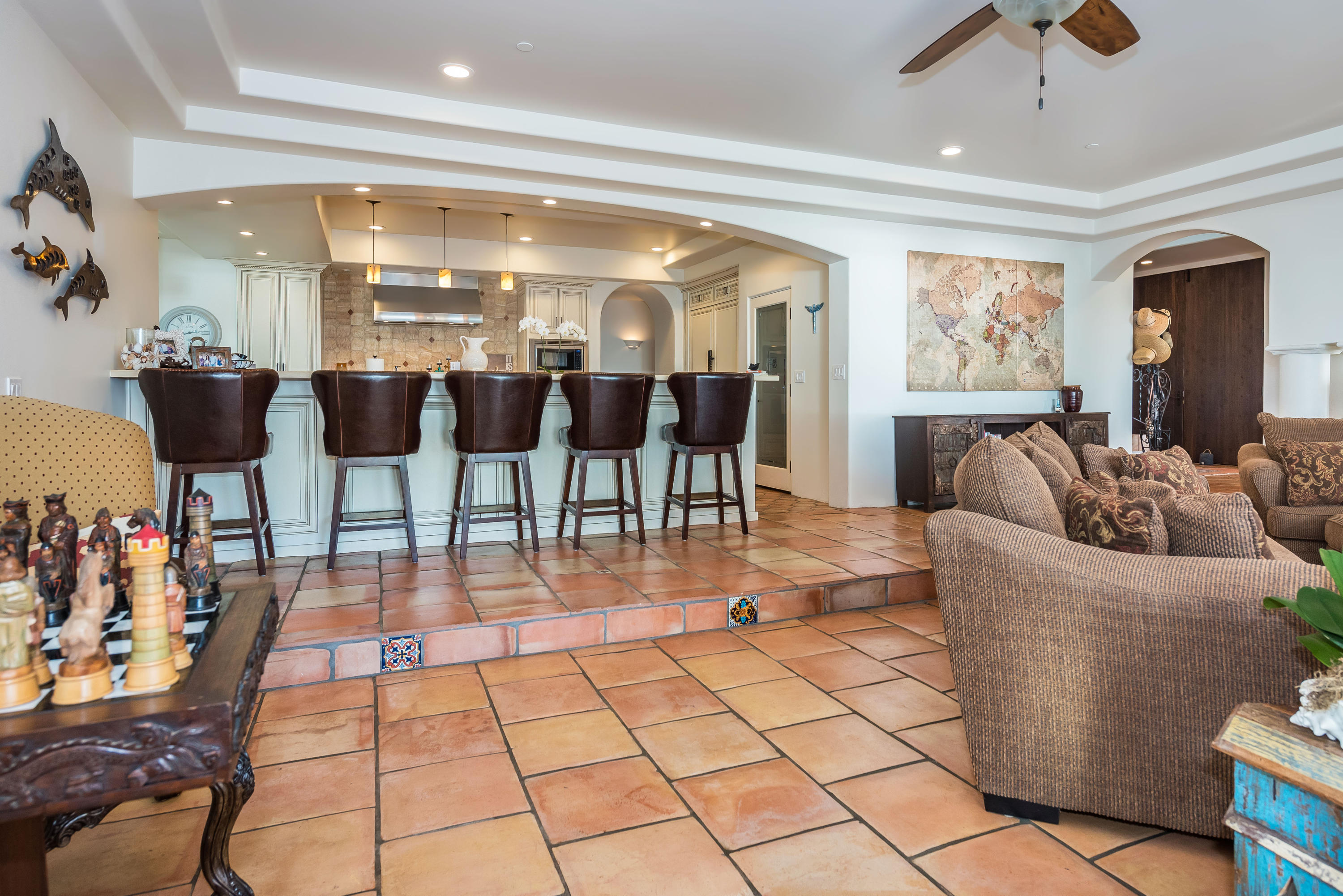 875 Sand Point Road Carpinteria, CA 93013 - Photo 6 of 25 a living room with lots of furniture and a chandelier