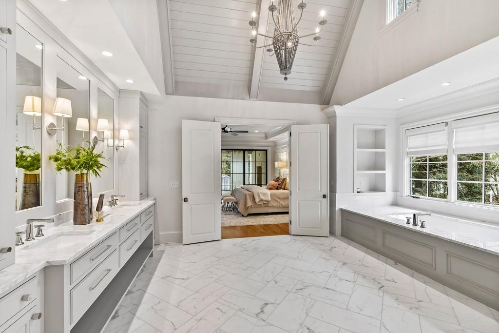 258 Pineland Road Northwest Atlanta, GA 30342 - Photo 54 of 87 a spacious en suite bathroom with a granite countertop tub and a large window