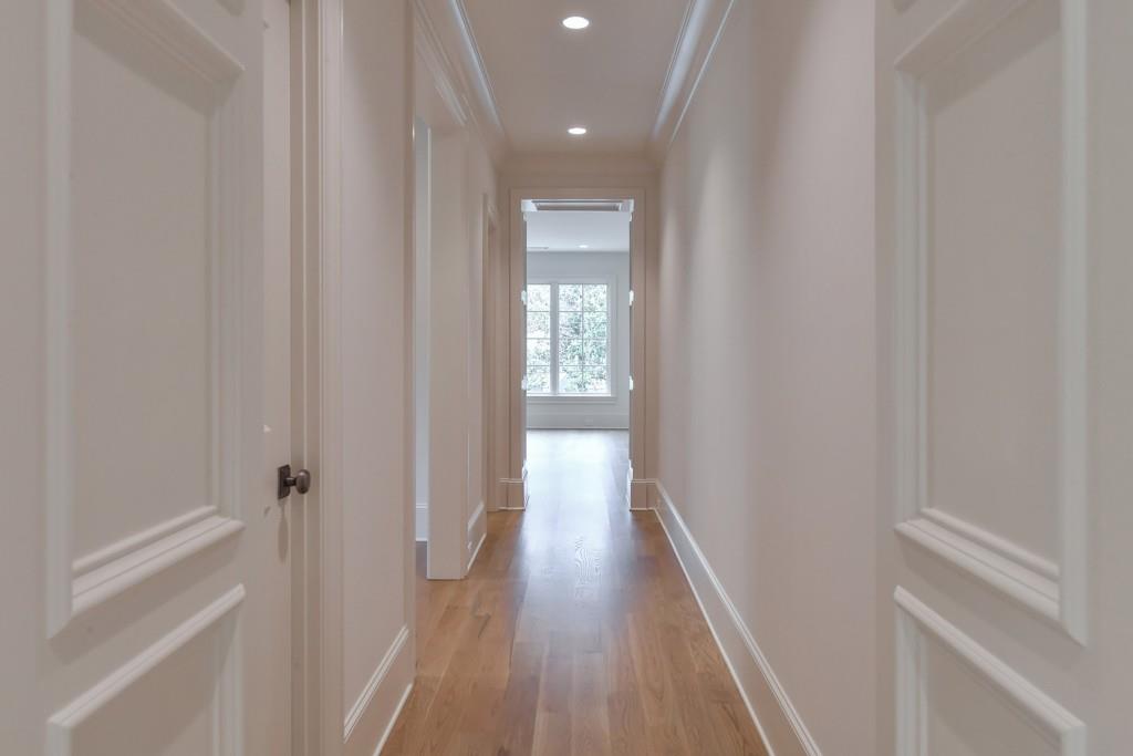 258 Pineland Road Northwest Atlanta, GA 30342 - Photo 60 of 87 a view of a hallway with wooden floor and a bathroom