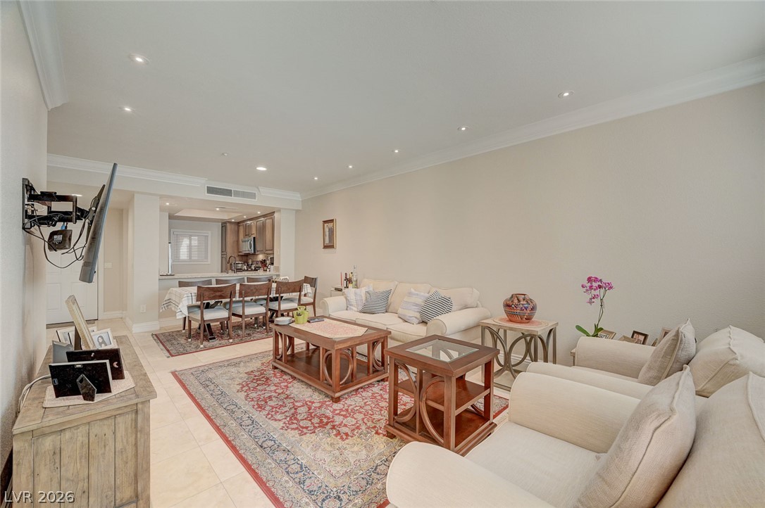 230 East Flamingo Road, Unit 106 Las Vegas, NV 89169 - Photo 64 of 66 Recessed lighting illuminates this bright, inviting living space, offering an open floorplan into the adjacent dining area.