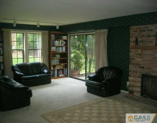 4701 Stonehedge Road Edison, NJ 08820 - Photo 2 of 8 a living room with furniture and a flat screen tv