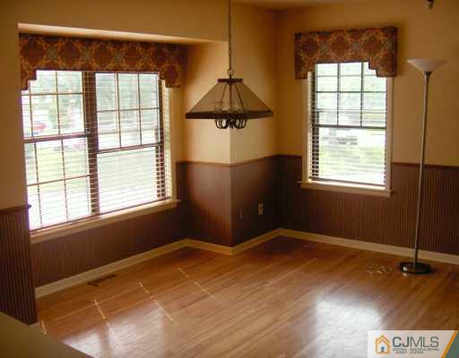 4701 Stonehedge Road Edison, NJ 08820 - Photo 5 of 8 a view of an empty room with a window