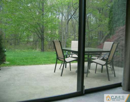 4701 Stonehedge Road Edison, NJ 08820 - Photo 6 of 8 a view of a patio with a table chairs and a backyard