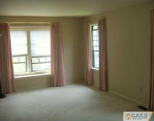 4701 Stonehedge Road Edison, NJ 08820 - Photo 7 of 8 an empty room that has a window