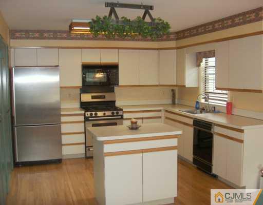 4701 Stonehedge Road Edison, NJ 08820 - Photo 8 of 8 a kitchen with a stove and a refrigerator