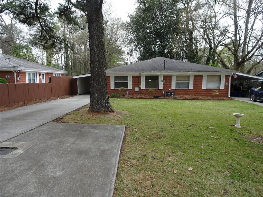 283 Lake Drive Atlanta, GA 30340 - Photo 4 of 14 a front view of a house with garden