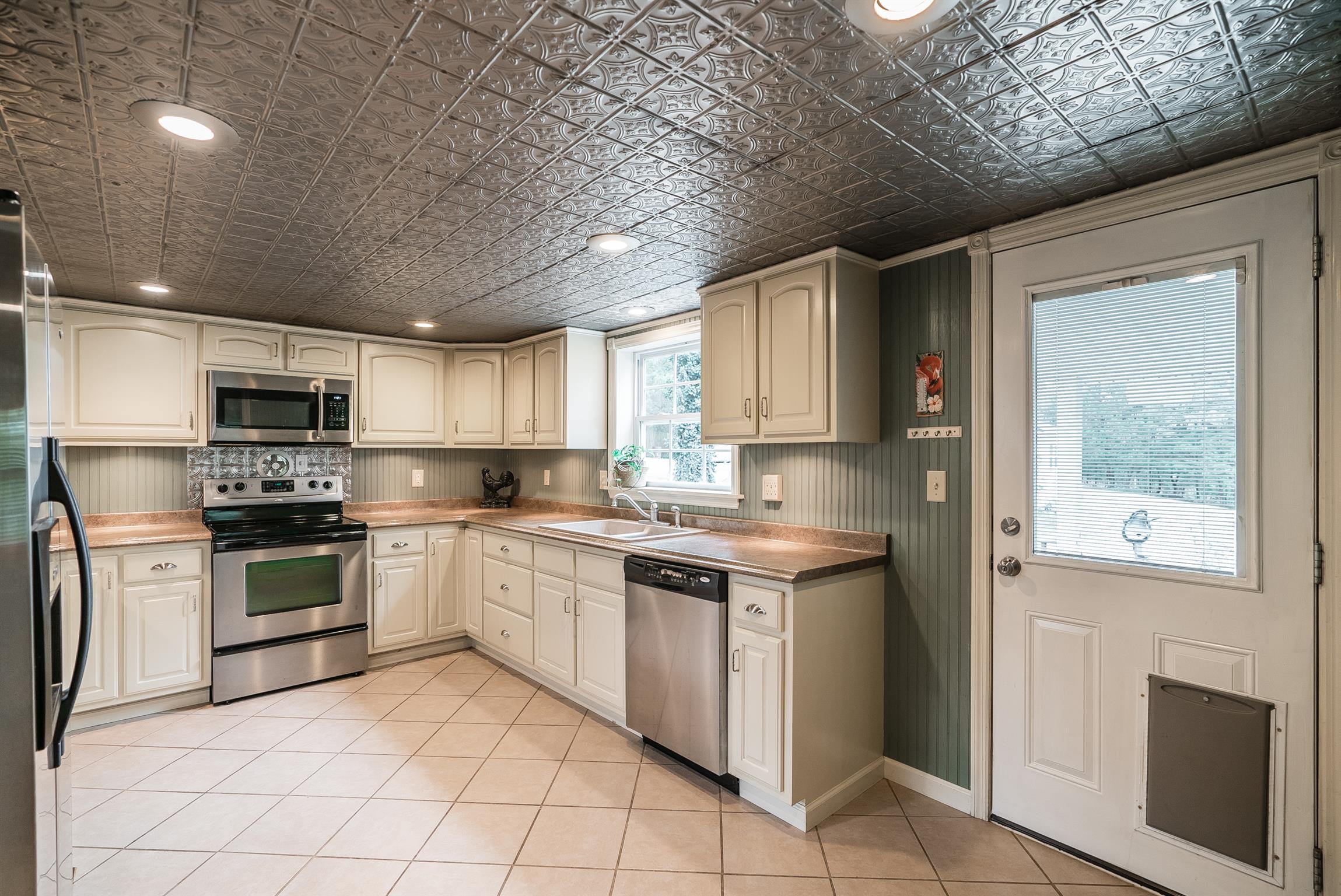 88 Canoe Branch Road Lebanon, TN 37087 - Photo 5 of 30 a kitchen with stainless steel appliances granite countertop a stove sink and cabinets