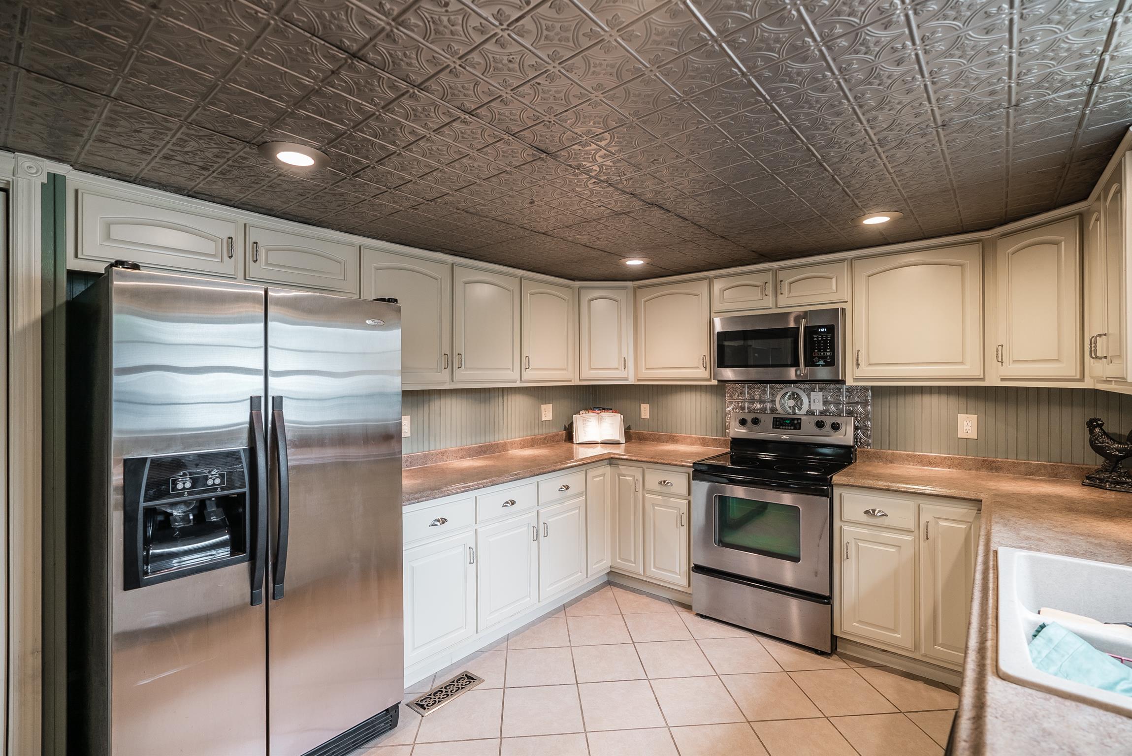 88 Canoe Branch Road Lebanon, TN 37087 - Photo 6 of 30 a kitchen with stainless steel appliances granite countertop a sink a stove a refrigerator and cabinets