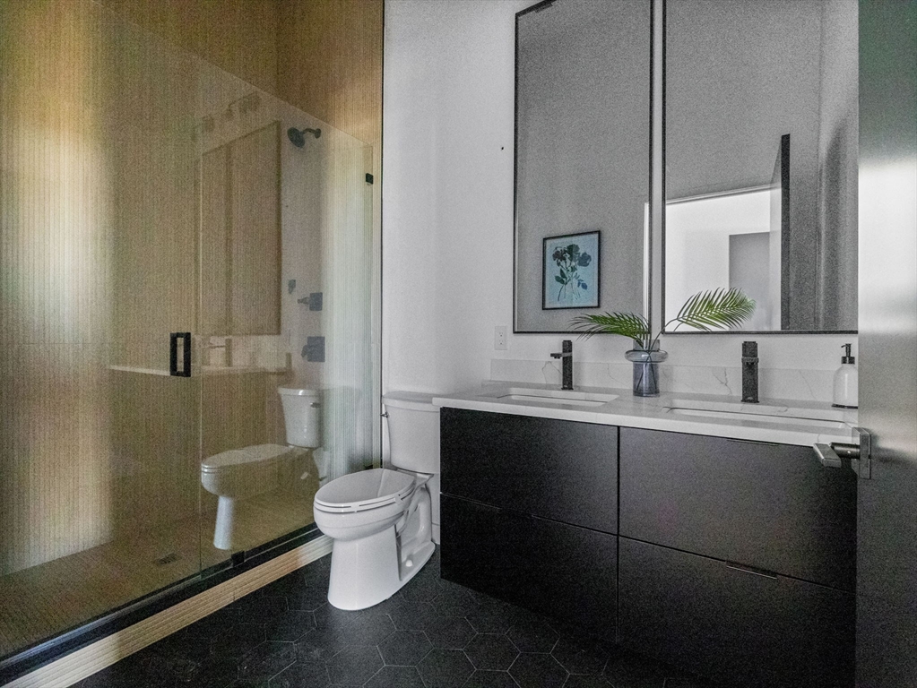 22 High Street, Unit 202 Boston, MA 02122 - Photo 4 of 11 a bathroom with a sink toilet and shower