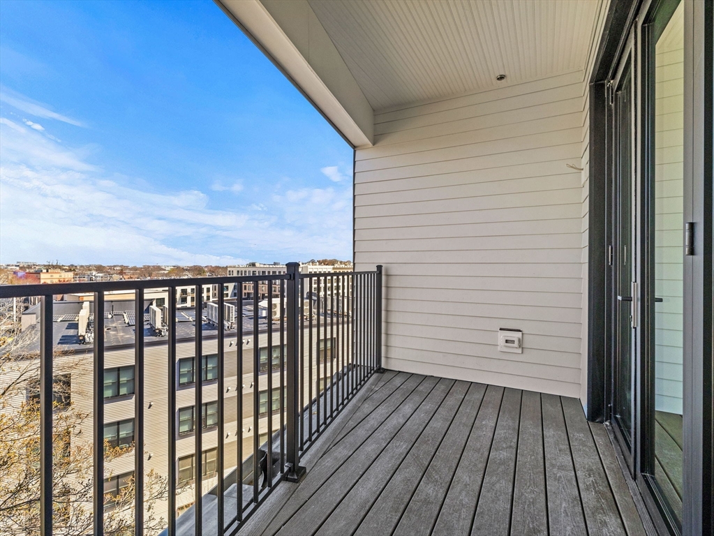 22 High Street, Unit 202 Boston, MA 02122 - Photo 10 of 11 a view of a balcony with wooden floor