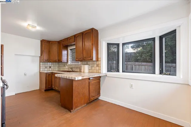 a kitchen with granite countertop a stove and a sink