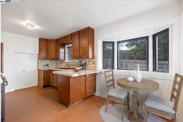 a kitchen with a sink cabinets and wooden floor