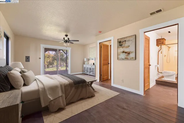a bedroom with a large bed and a window