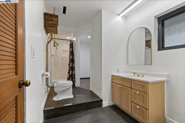 a bathroom with a toilet sink and mirror