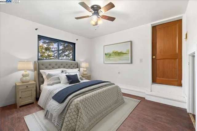 a bedroom with a bed and a painting on the wall