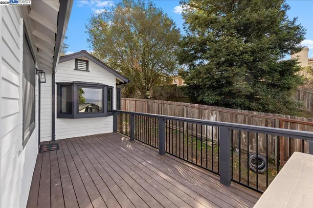a view of a balcony with wooden floor and fence